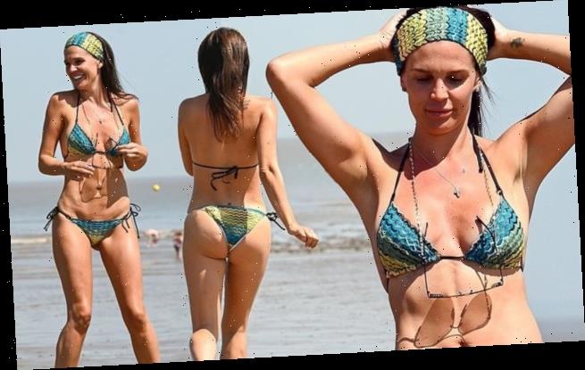Bikini-clad Danielle Lloyd showcases her figure as she larks around with hu...